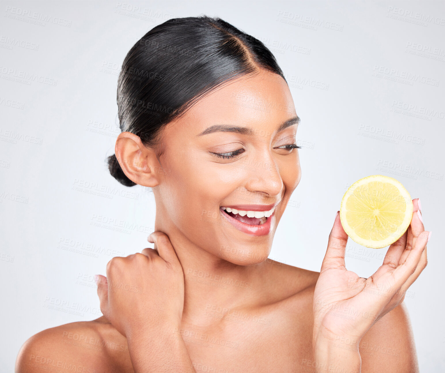 Buy stock photo Face, skincare and lemon with a natural woman in studio on a white background for vitamin C nutrition. Smile, beauty and fruit with a happy young model looking confident in organic treatment