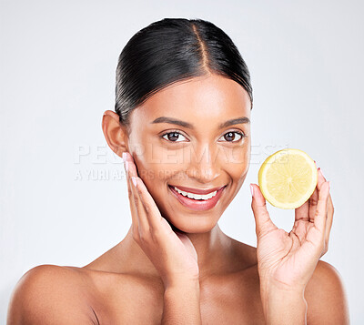 Buy stock photo Portrait, beauty and lemon with a natural woman in studio on a white background for vitamin C nutrition. Face, skincare and fruit with a happy young model looking confident in organic treatment