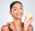 Face, happy and woman with lemon, beauty and facial with natural skincare isolated on white background. Wellness, fruit and vegan cosmetic product with glow, shine and vitamin c with citrus in studio