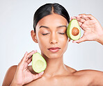Face, avocado and woman with natural beauty, facial and eco friendly skincare isolated on white background. Wellness, dermatology and vegan cosmetics product with glow, shine and green in studio