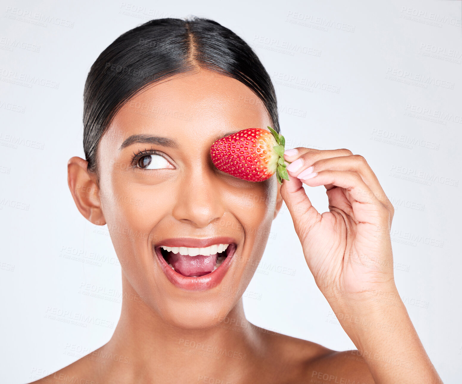 Buy stock photo Health, smile and woman with a strawberry in studio for healthy diet snack for nutrition. Wellness, beauty and young Indian female model with fruit for natural skin detox routine by white background.