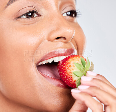 Buy stock photo Eating healthy, diet and a woman with a strawberry on a white background for nutrition and hungry. Smile, young and a girl or Indian model with fruit for health, wellness and detox on a backdrop