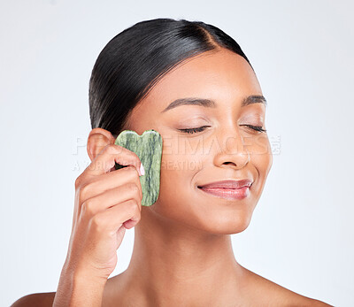 Buy stock photo Woman, face and gua sha, natural beauty and tools with jade stone for skincare isolated on white background. Facial massage, facelift and grooming with skin glow, dermatology and wellness in studio