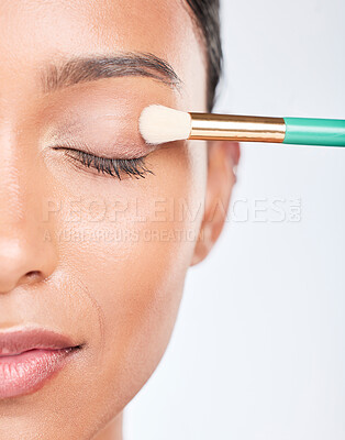 Buy stock photo Woman, makeup and eye brush in studio for beauty, skincare or apply facial powder on white background. Closeup, face of model and cosmetic tools for eyeshadow glow, dermatology and aesthetic makeover