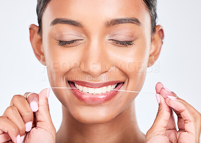 Buy stock photo Mouth, flossing and dental with woman and face, health and fresh breath isolated on white background. Cleaning plaque, thread and teeth whitening with oral care, orthodontics and routine in studio
