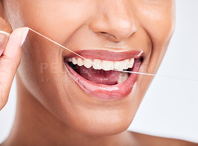 Buy stock photo Mouth, flossing and dental with woman and closeup, health and fresh breath isolated on white background. Cleaning plaque, thread and teeth whitening with oral care, orthodontics and routine in studio