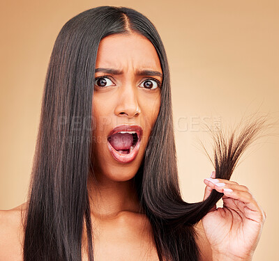 Buy stock photo Hair care, shock and portrait of woman in a studio with split ends for salon keratin treatment. Beauty, cosmetic and surprised Indian female model with hairstyle isolated by a brown background.