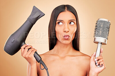 Buy stock photo Happy, thinking and a woman with a blowdryer on a studio background for haircare, styling or salon. Goofy, keratin and an Indian model or person with electric product for a hairstyle or treatment