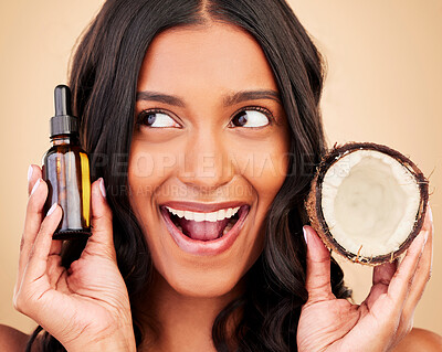 Buy stock photo Happy woman, hair and beauty, coconut oil product with natural treatment and cosmetic care on studio background. Haircare, eco friendly and vegan with fruit, serum and shampoo with bottle and shine