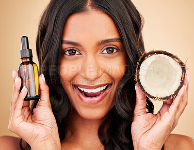 Buy stock photo Hair, woman and coconut oil, beauty and cosmetic care with wellness and treatment in portrait on studio background. Haircare, fruit and shine with texture and growth, natural liquid product and vegan