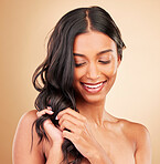Hair care touch, happy woman and curly beauty in studio isolated on brown background. Hairstyle, natural cosmetics and model in salon treatment for texture growth, balayage and aesthetic for wellness