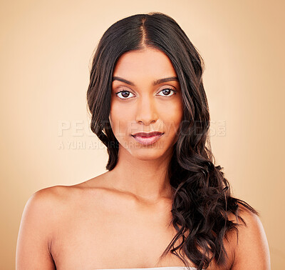 Buy stock photo Hair care, curly and face of woman in studio isolated on a brown background. Beauty hairstyle, natural cosmetics and portrait of serious Indian model in salon treatment for health, wellness and skin