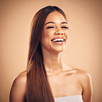 Portrait, smile and hair with a natural woman in studio on a brown background for keratin treatment. Face, beauty and shampoo with a happy young model at the salon for growth or aesthetic haircare