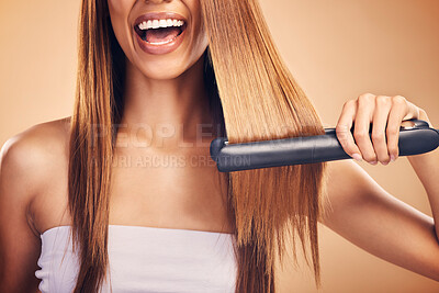 Buy stock photo Hand, hair straightener and woman in studio for beauty, cosmetics or appliance. Happy person on brown background for heat treatment, healthy results and hairdresser or salon flat iron on texture