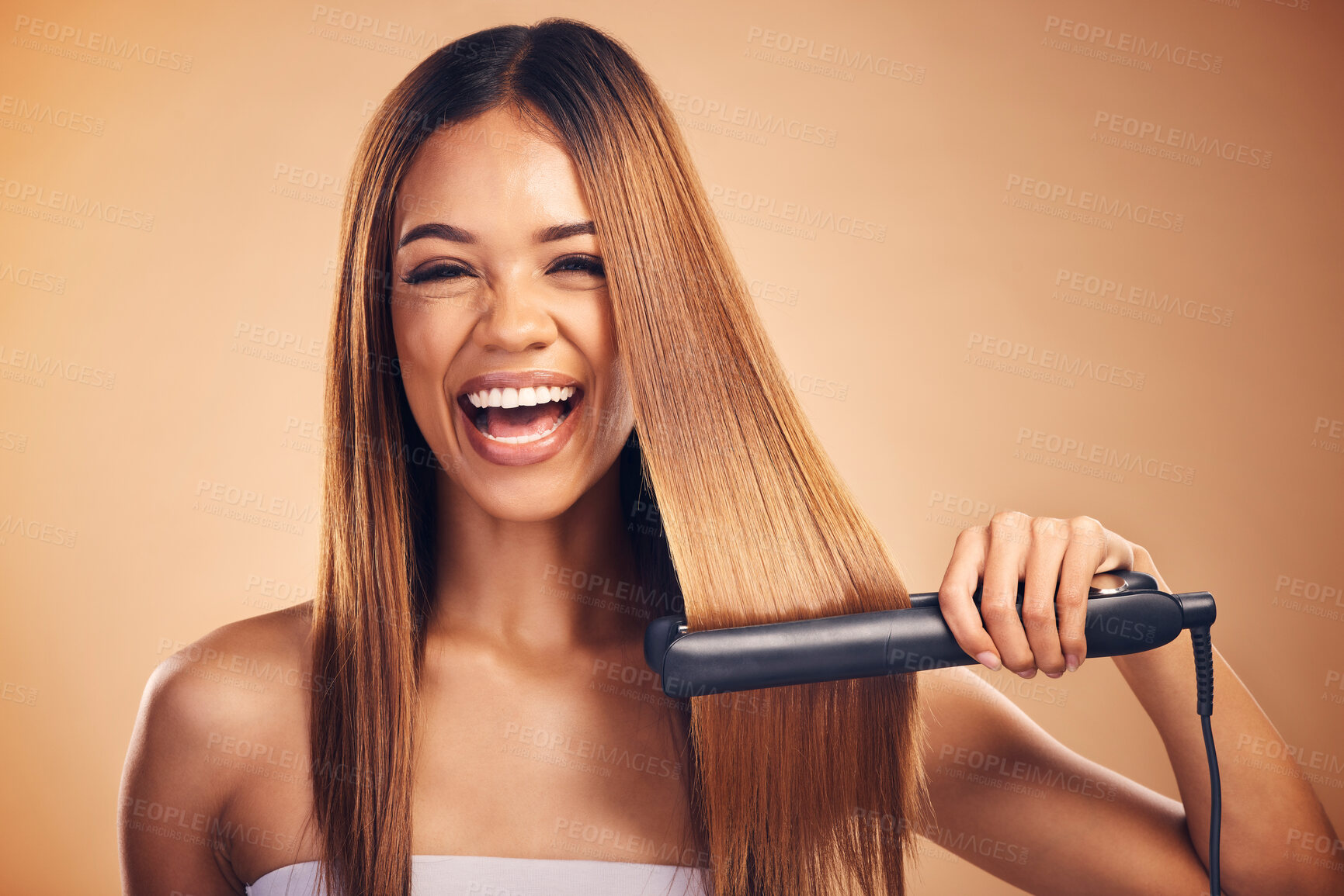 Buy stock photo Happy, hair straightener and portrait of woman in studio for beauty, cosmetics or appliance. Excited person on brown background for heat treatment, healthy results and hairdresser or salon flat iron