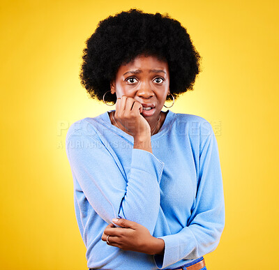 Buy stock photo Biting nails, anxiety and a scared woman in studio for fear, mental health or nervous behaviour. Portrait of African person on yellow background worried, stress or panic for phobia, terror or horror