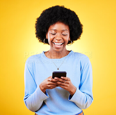 Buy stock photo Woman, smile and typing on smartphone on in studio, reading social media and funny meme on yellow background. Happy african model, cellphone and download games, dating app or multimedia notification 