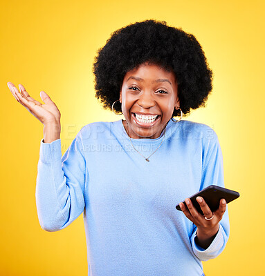 Buy stock photo Phone, excited and a woman in studio for win, competition announcement and wow emoji. Happy black person or winner with a smartphone on a yellow background for success, social media crush or chat