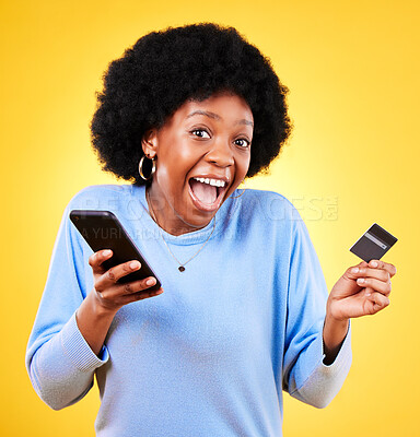 Buy stock photo Happy black woman, portrait and phone with credit card in online shopping against a yellow studio background. Excited African female person with afro on smartphone for ecommerce, payment or banking