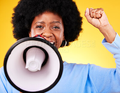 Buy stock photo Black woman, portrait and megaphone with fist in protest, fight or march against a yellow studio background. African female person or activist with noise, bullhorn or loudspeaker in voice or justice