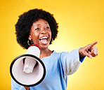 Happy woman, loudspeaker or megaphone and pointing in studio for voice or announcement. African person with speaker for broadcast message, breaking news or speech communication on yellow background
