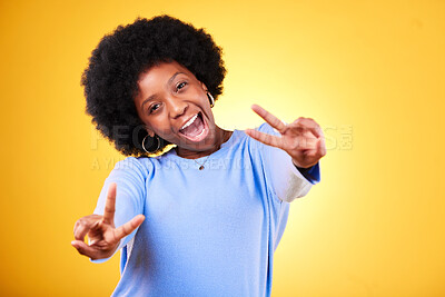 Buy stock photo Peace, hand sign and portrait of a woman in studio with fun emoji, excited face and v symbol. Happy african person on yellow background for positive mood, motivation and review with gesture or vote
