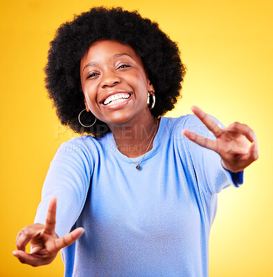 Buy stock photo Hand sign, peace and portrait of a woman in studio with fun emoji, excited face and v symbol. Happy african person on yellow background for positive mood, motivation and review with gesture or vote