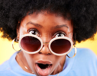 Surprise, black woman and shock on face with sunglasses, fashion and crazy sale, deal or offer in studio background. Confused, portrait and African person with shocked, wow or emoji for promotion