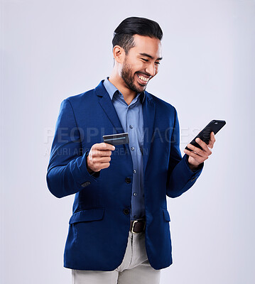 Buy stock photo Credit card, phone and a business man in studio for online shopping, fintech payment or website. Asian person with a smartphone and finance for savings, e commerce or banking on a grey background