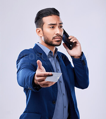 Buy stock photo Credit card, phone call and a business man in studio for communication or fintech payment. Asian person, smartphone and finance for membership subscription, account or banking info on grey background