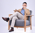 Portrait, serious and a man psychologist in a chair on a white background in studio to listen for diagnosis. Psychology, mental health and concern with a person counseling during a therapy session