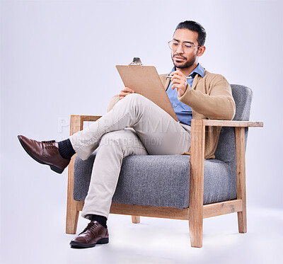 Buy stock photo Documents, diagnosis and a man psychologist in a chair on a white background in studio to listen for diagnosis. Psychology, mental health and trauma with a person counseling during a therapy session