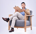 Portrait, question and a man psychologist in a chair on a white background in studio to listen for diagnosis. Psychology, mental health and documents with a person counseling during a therapy session