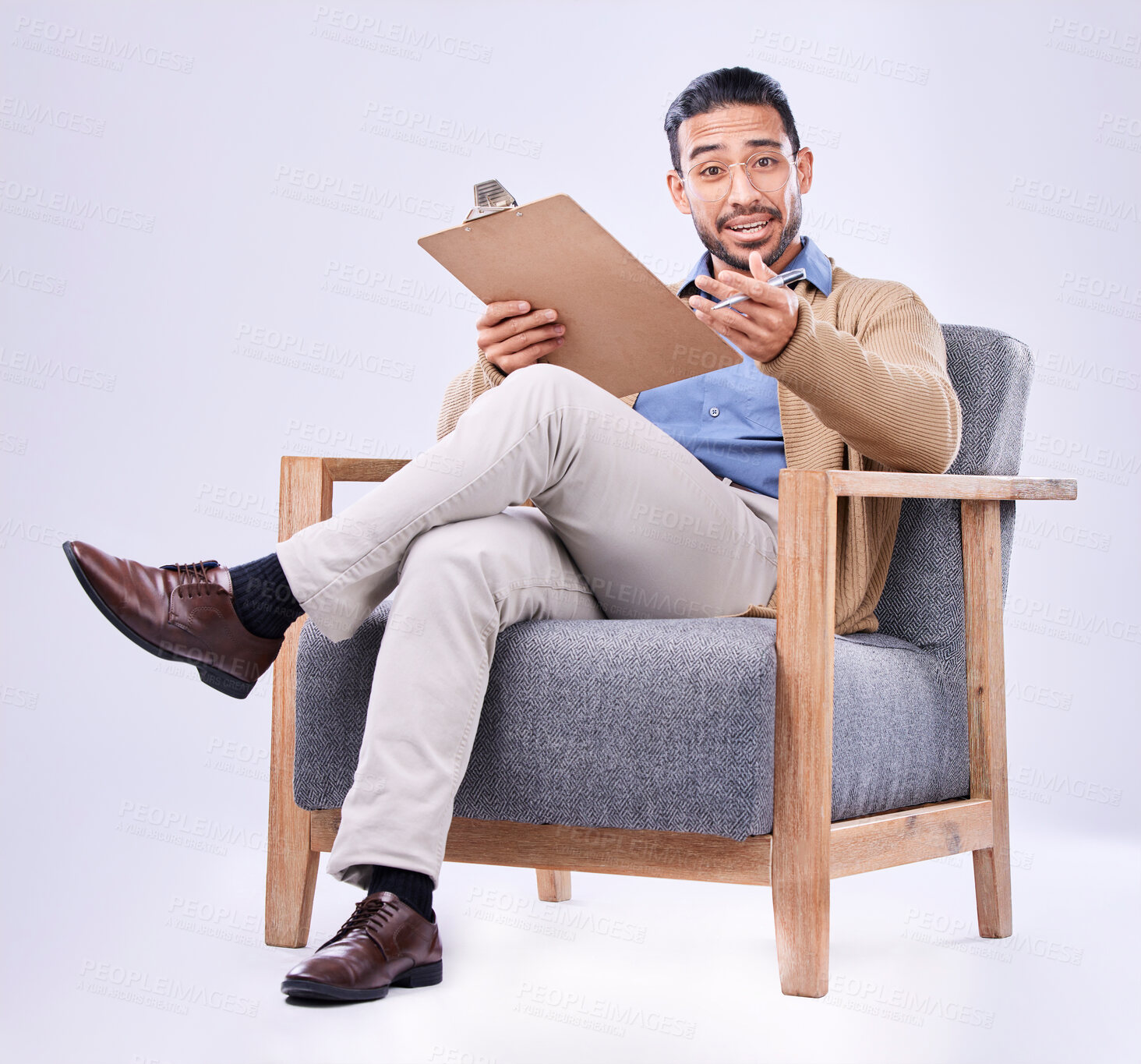 Buy stock photo Portrait, question and a man psychologist in a chair on a white background in studio to listen for diagnosis. Psychology, mental health and documents with a person counseling during a therapy session