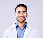 Happy, portrait and man doctor in a studio with glasses for vision, eye care and wellness. Smile, confidence and headshot of an Indian male healthcare professional with spectacles by white background