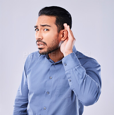 Buy stock photo Hands, ear and portrait of frustrated man in studio for gossip, listening or speak up sign on grey background. Palm, secret and face of Japanese guy with emoji icon for deaf, sign language or what