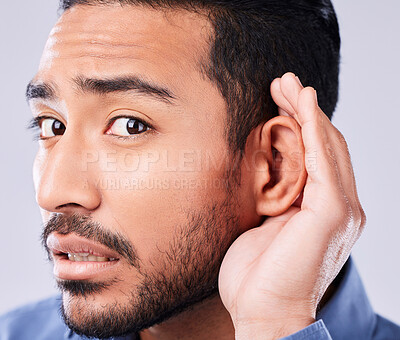Buy stock photo Whisper, portrait and hand on ear of man in studio with speak up, listen or announcement on grey background. Gossip, face and Asian guy model with emoji for what, pardon or curious, listening or news