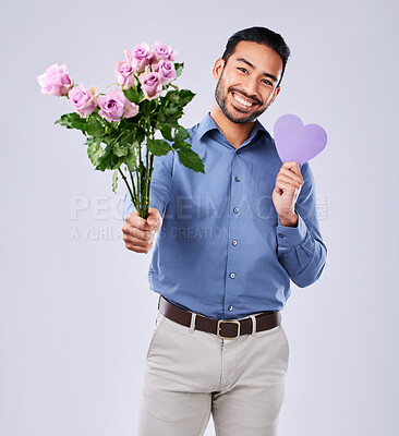 Roses, portrait and asian man with purple heart in studio for thank you, gift or care on grey background. Paper, frame and Japanese male model with flower, bouquet or offer, love or valentines day