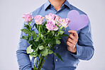 Flowers, man and heart in studio for love on grey background, roses and gift for thank you or present. Bouquet, person and purple paper frame, care and support for valentines day, date or offer