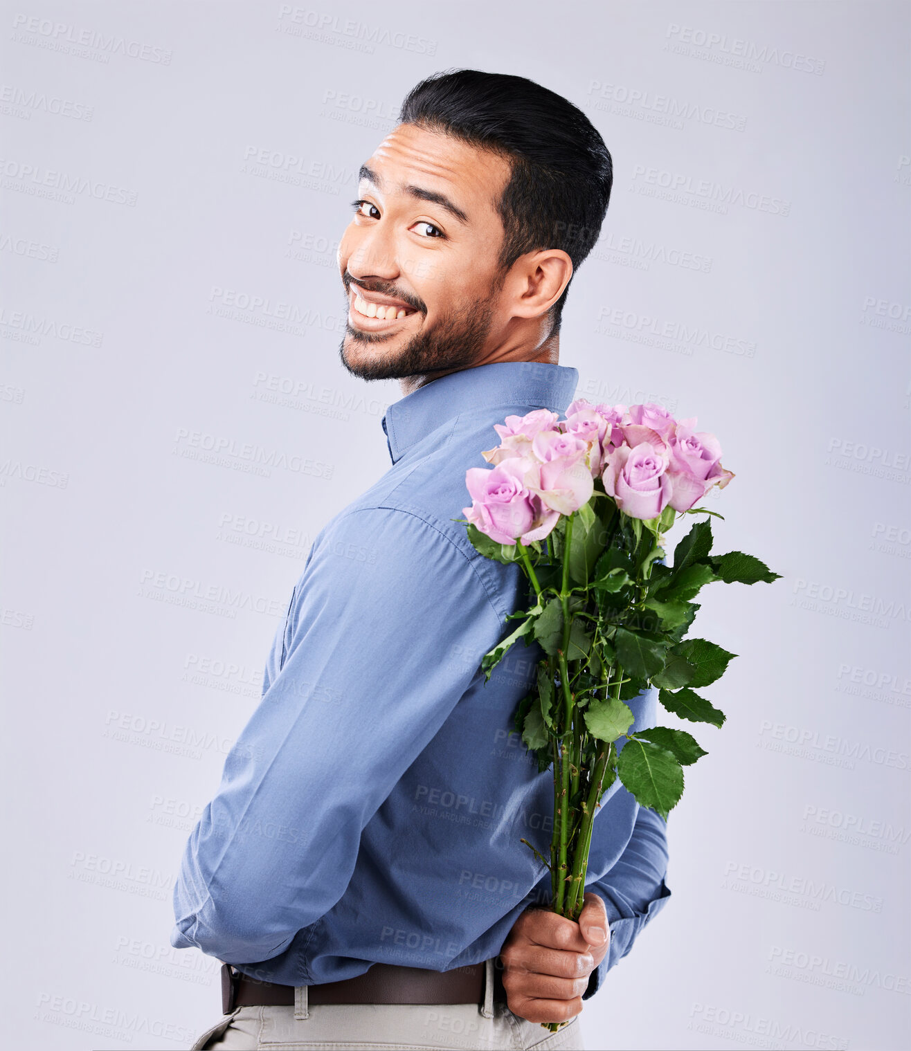 Buy stock photo Flowers, portrait and man in studio with surprise roses in celebration of valentines day or romance on grey background. Face, smile and male person with floral gift for love, care or romantic gesture