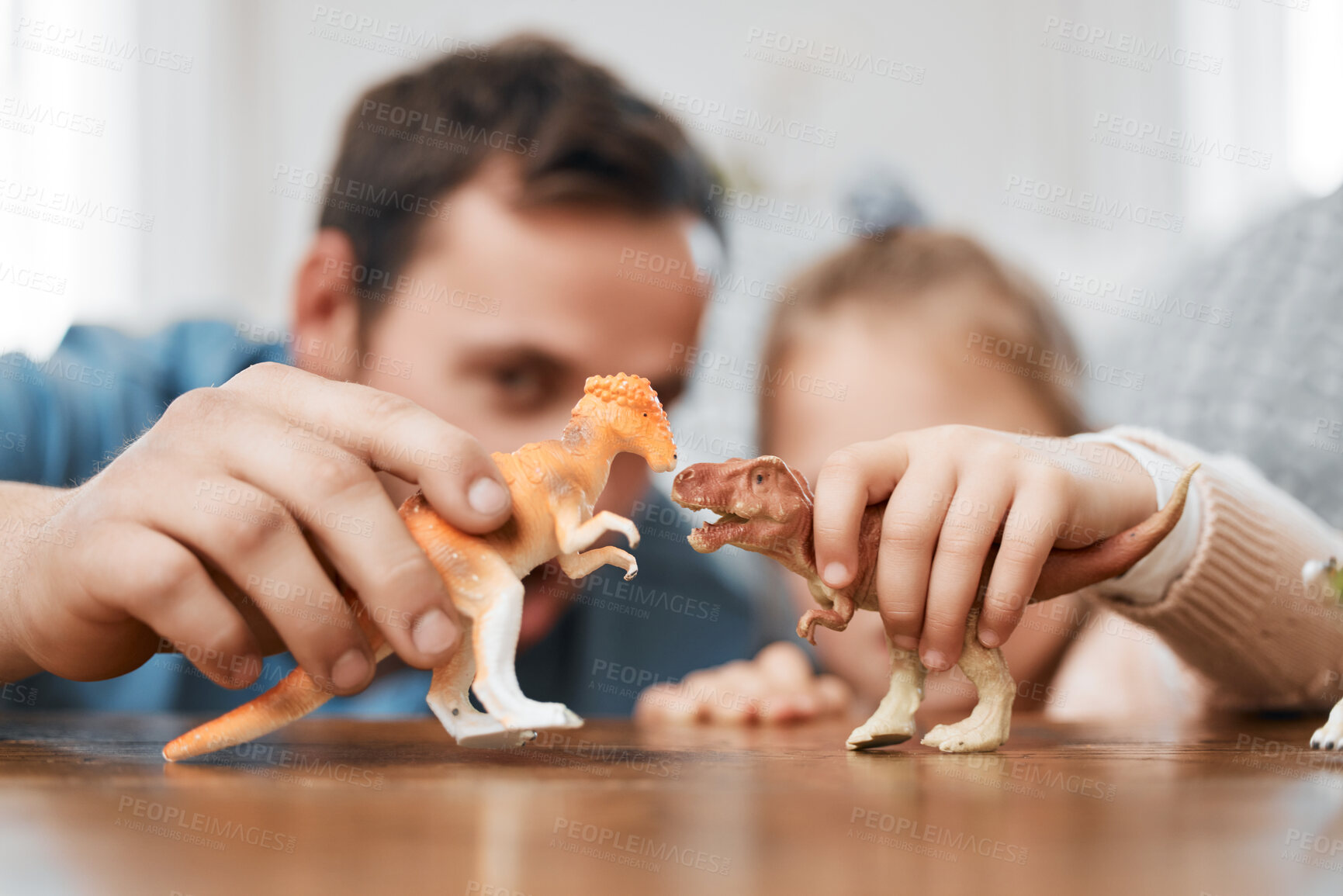 Buy stock photo Playing, dinosaur and the hands of a father and child for bonding, childhood and on a table. Closeup, together and a man, dad or kid with a toy for happiness, entertainment or family in a house