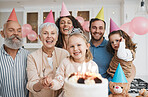 Birthday party, gift and portrait of big family celebrate with cake in home event and candles in a house together. Mother, father and grandparents excited for surprise gathering with children or kids