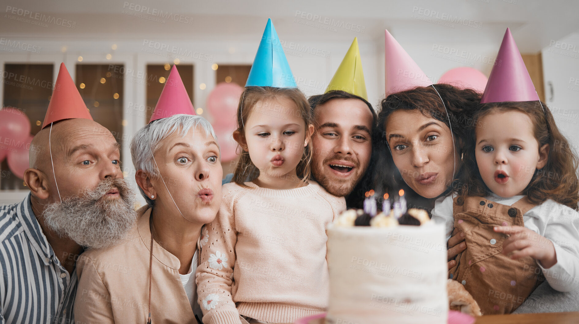 Buy stock photo Happy birthday, gift and big family blowing candles with cake in a home party, event and celebration together. Mother, father and grandparents excited for surprise gathering with children or kids