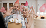 Happy birthday, gift and senior couple celebrate with cake in a home party, event and candles in a house together. Man, woman and elderly excited for surprise gathering with children or kids