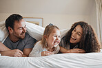 Laugh, happy and family in bed together bonding with comic, comedy or funny joke together. Smile, love and young girl child relaxing and having fun with her mother and father in the bedroom at home.