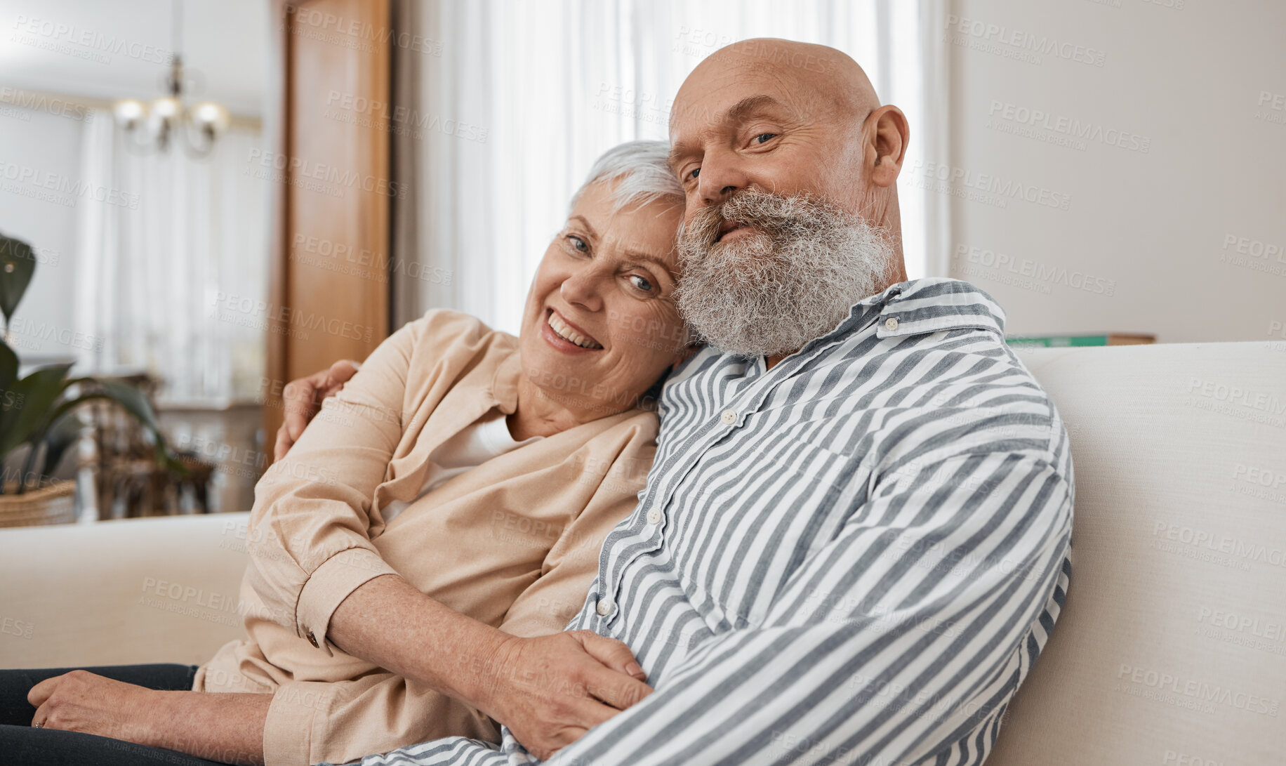 Buy stock photo Smile, portrait and senior couple on a sofa in the living room of modern home for bonding. Happy, love and elderly man and woman in retirement hugging and relaxing together in the lounge of a house.