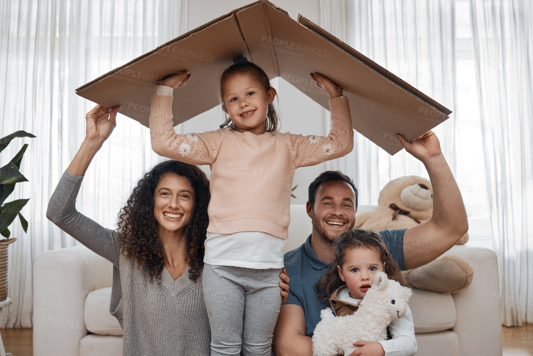 Buy stock photo Parents, kids and cardboard roof in portrait, smile or excited for security, property investment or insurance in family home. Mother, father and children with box, happy and together with new house