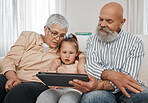 Relax, kid or grandparents with tablet for elearning or studying for education or remote learning at home. Family, grandfather or grandmother with girl reading ebook or streaming videos or movies 