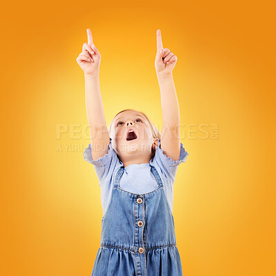 Buy stock photo Child, wow and hand pointing up in studio for advertising, announcement or promotion. Excited young girl kid on a orange background for gesture, sale or sign for attention or mockup marketing space