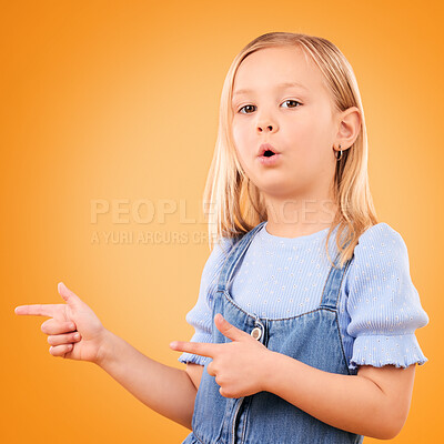 Buy stock photo Child, portrait and girl with finger gun in studio for advertising, announcement or promotion. Young kid on orange background for hand gesture, pointing or sign for direction, attention or marketing